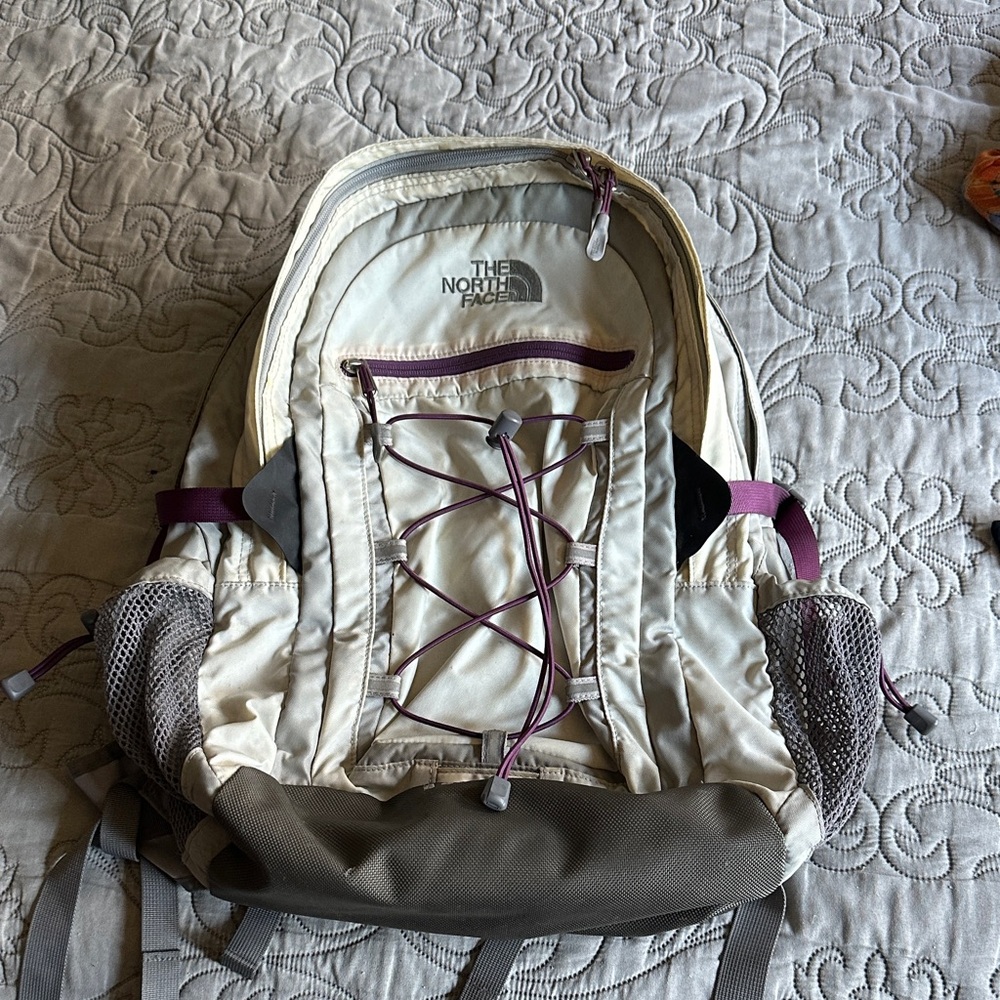 The North Face Borealis Cream and Gray Backpack with Purple Accents.